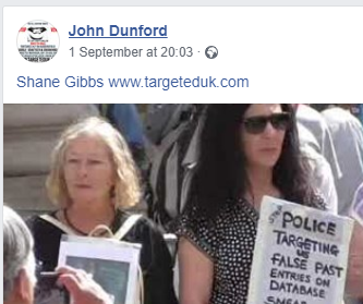 Her placard reads; Stop Police Targeting Us, False Past Entries On Database, Smear Campaigns.
